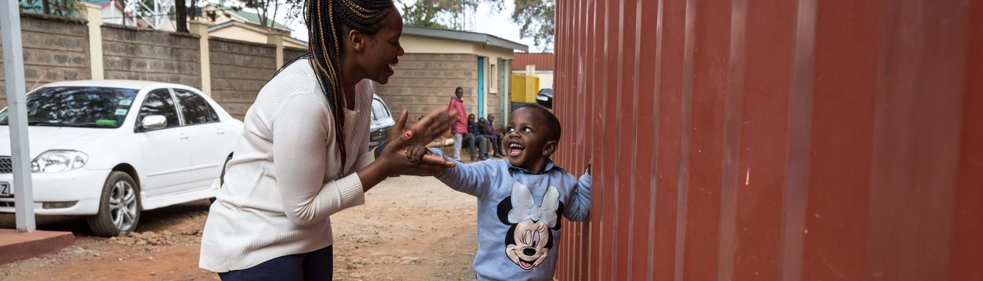 A woman signing to a young child