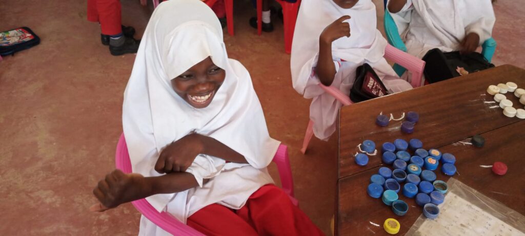 A happy girl sitting in a classroom