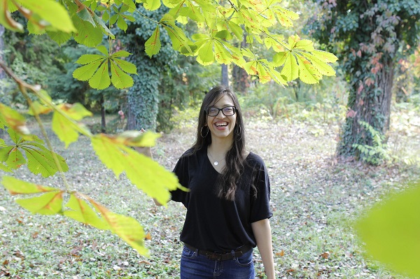 A young woman smiles at the camera