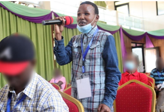 A young person standing at a microphone