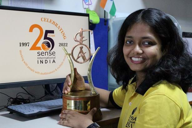 Smiling woman holding award