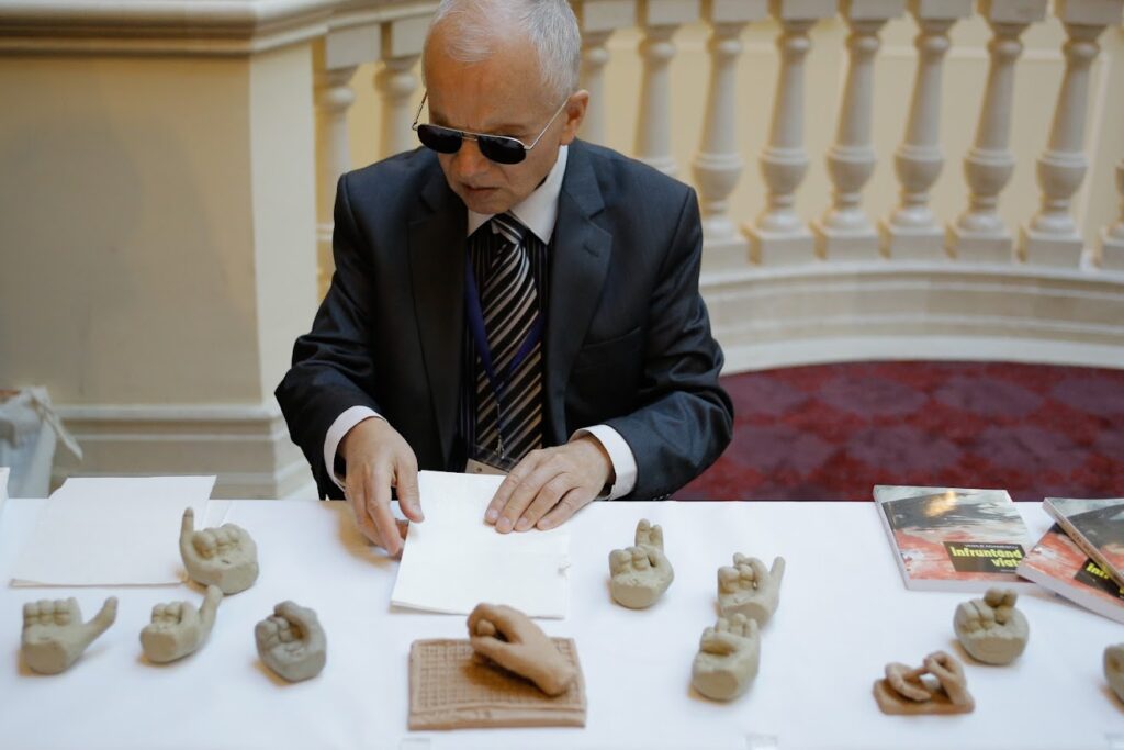 Vasile Adamescu sat at a table