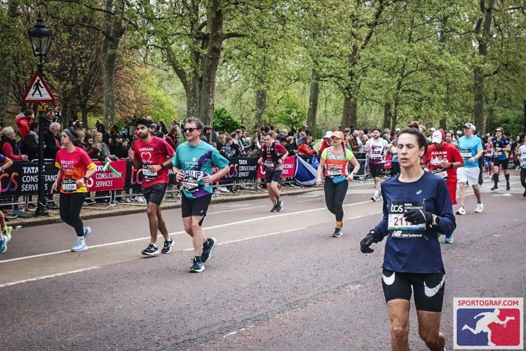 A group of runners including a man in a Sense International running shirt