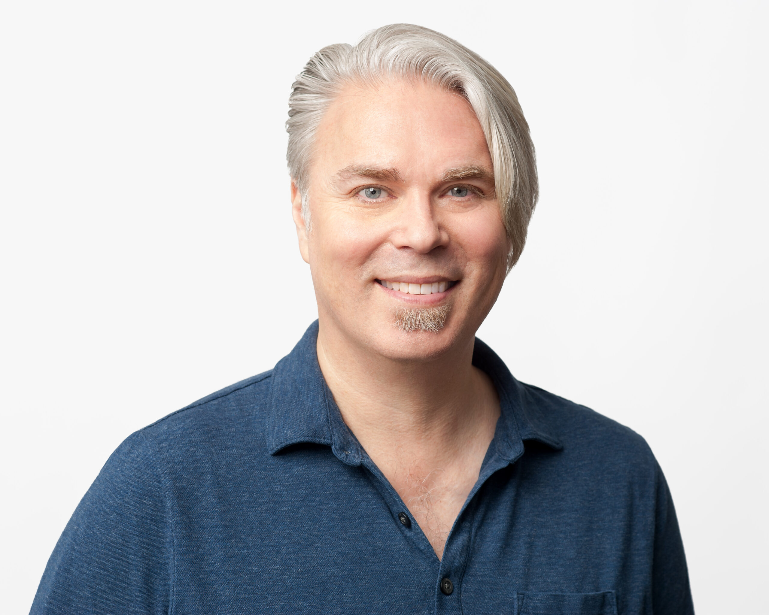 Christopher Patnoe from Google - a white man with long silver hair and a beard wearing a navy polo shirt