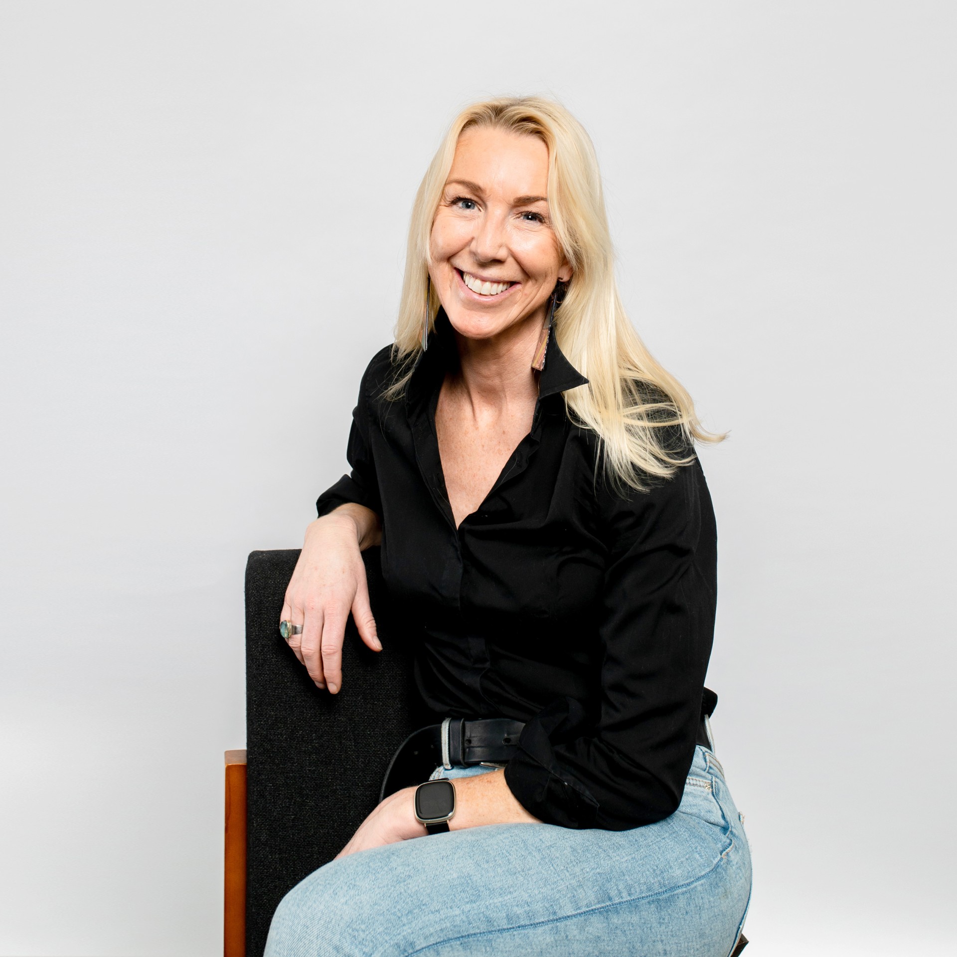 Caroline Casey - a white woman with long blonde hair wearing a black collared shirt