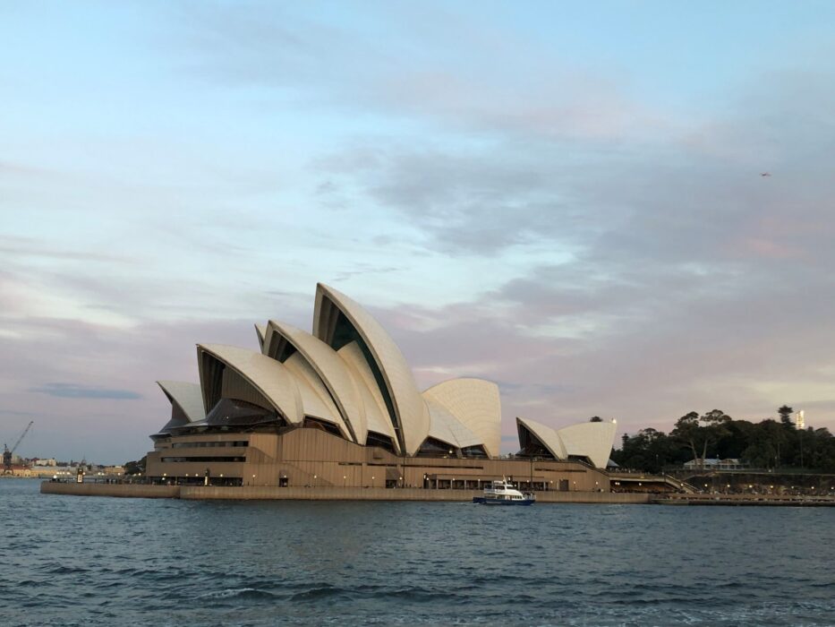 Sydney Opera House at dusk from across the harbour.
